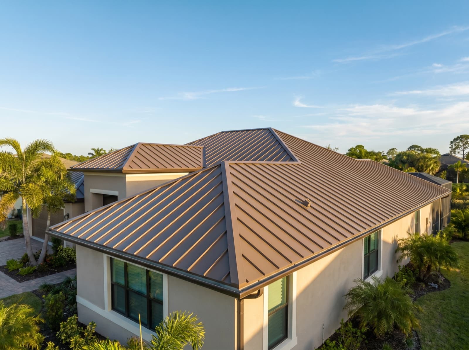 Medium bronze standing seam metal roof, color matched across the full run