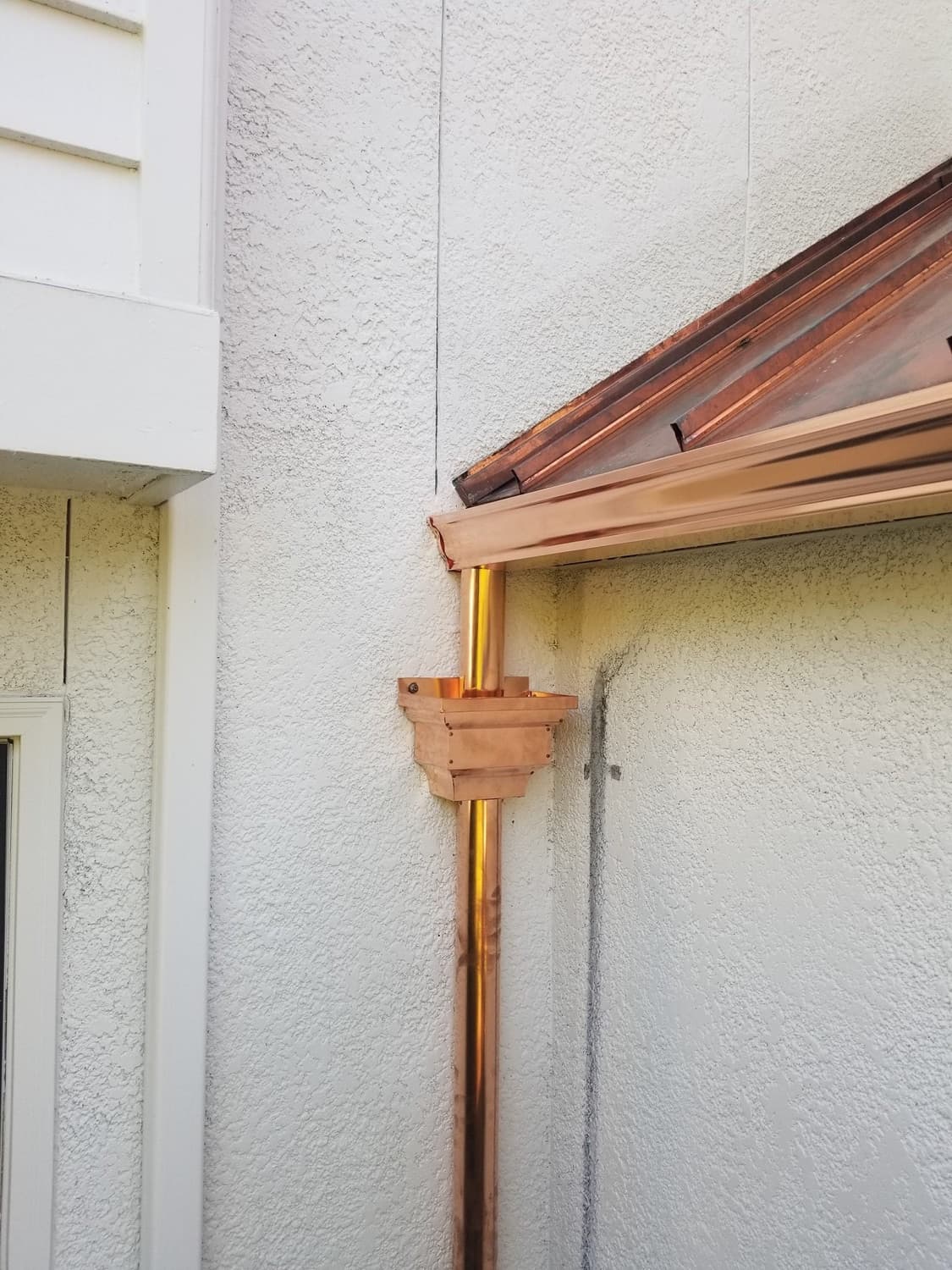 Copper standing seam metal roof in warm sunlight
