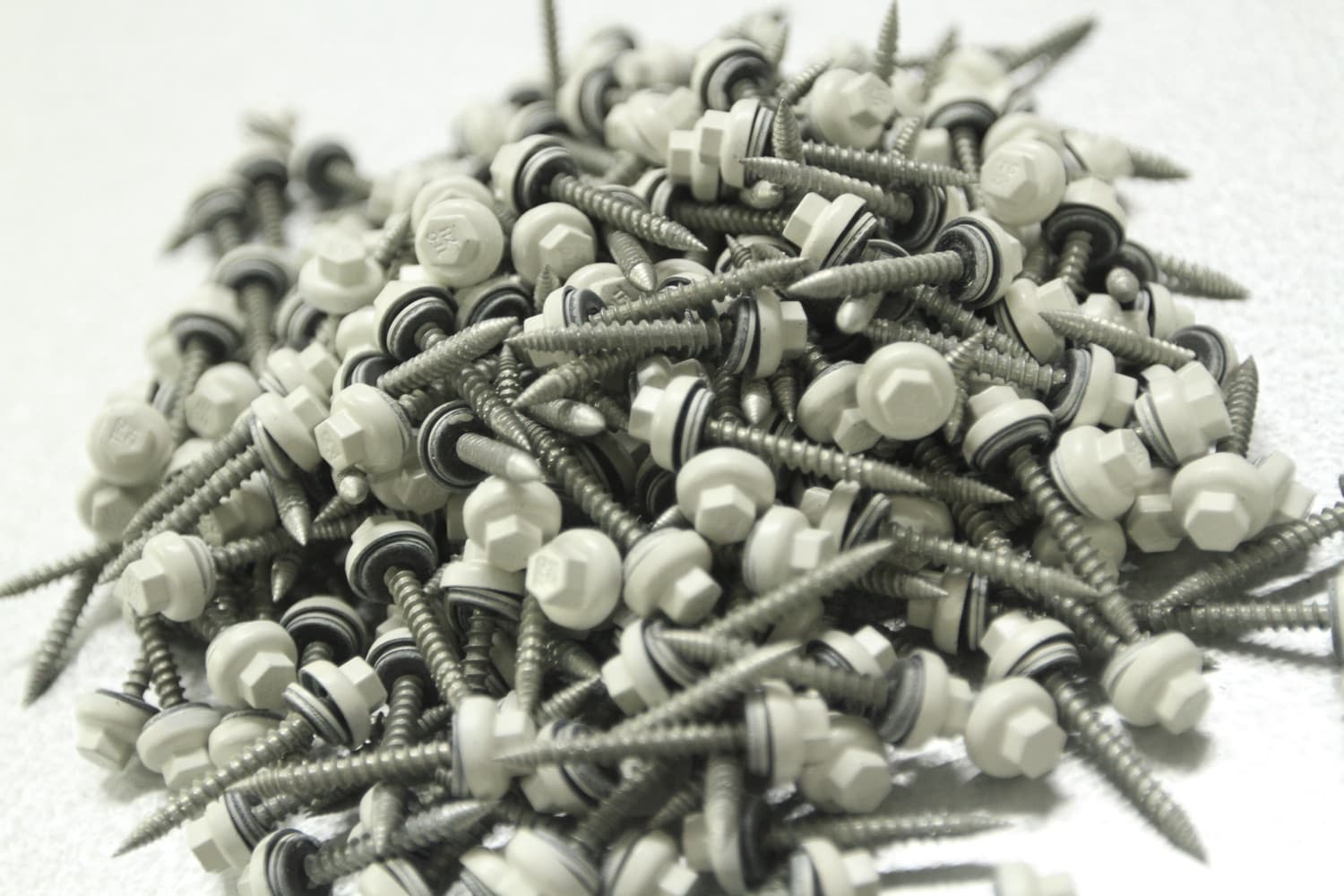 Coated lifetime metal roofing screws for a Florida wind-rated metal roof assembly